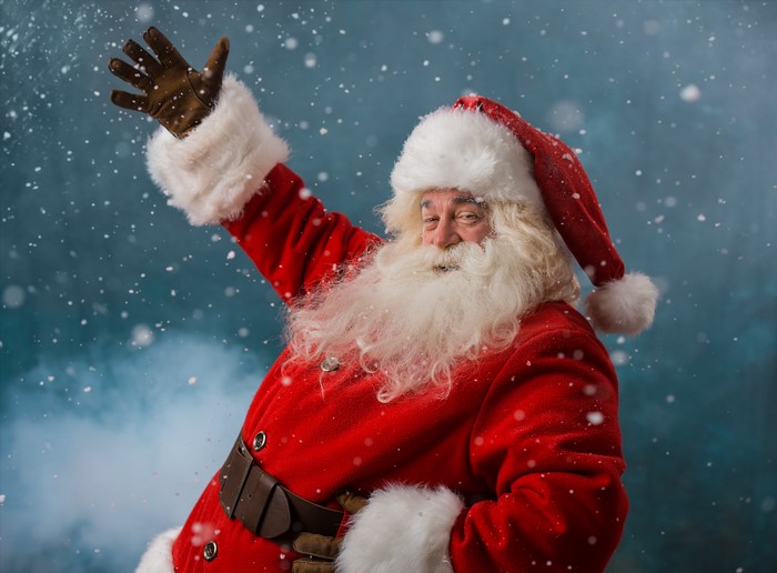 Santa Claus waving in the snow