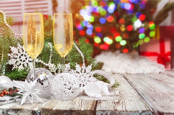 Champagne glasses with Christmas decorations on wood planks