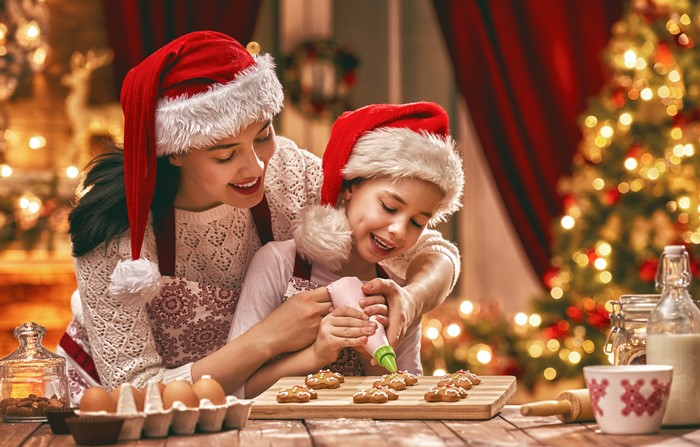 Mother and daughter decorating Christmas cookies