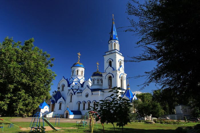 White and blue church with golden domes in Voronezh, Russia