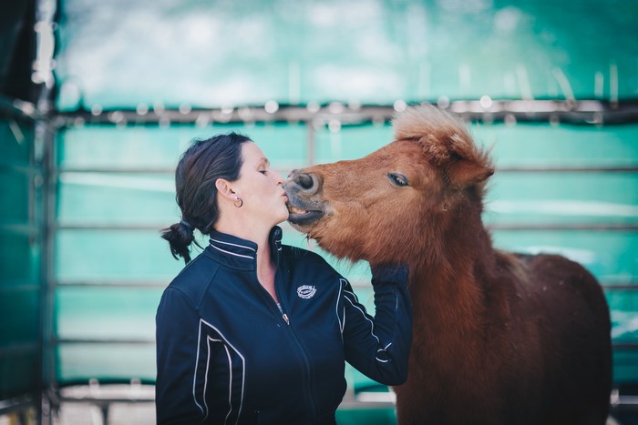 Woman kissing a horse
