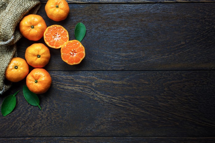 Mandarine on dark wood planks