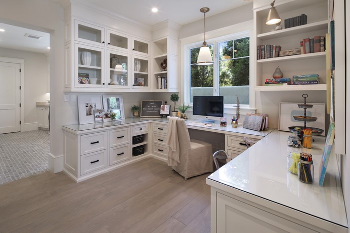 Home office with white cabinets and desk