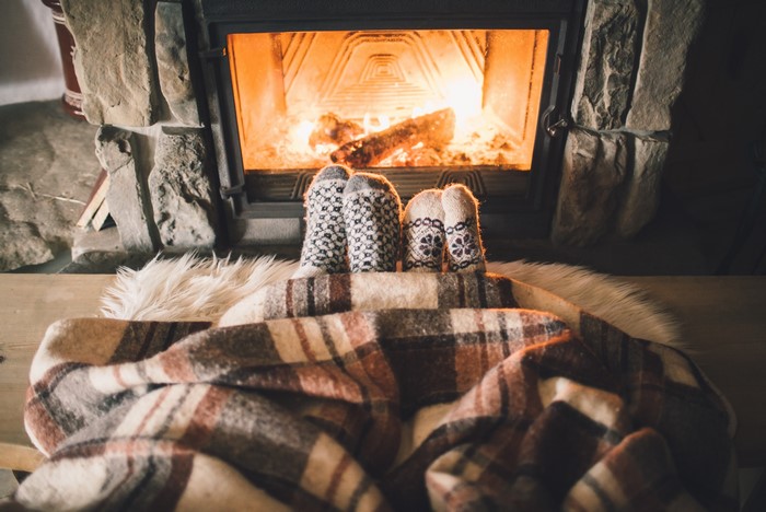 Feet in socks by fireplace
