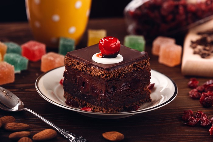 Chocolate cake with cherry on plate