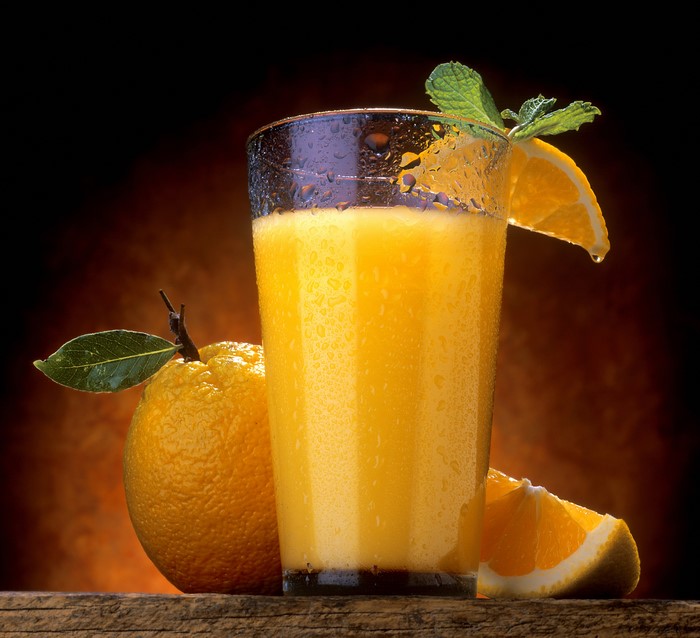 Orange juice in a glass with oranges