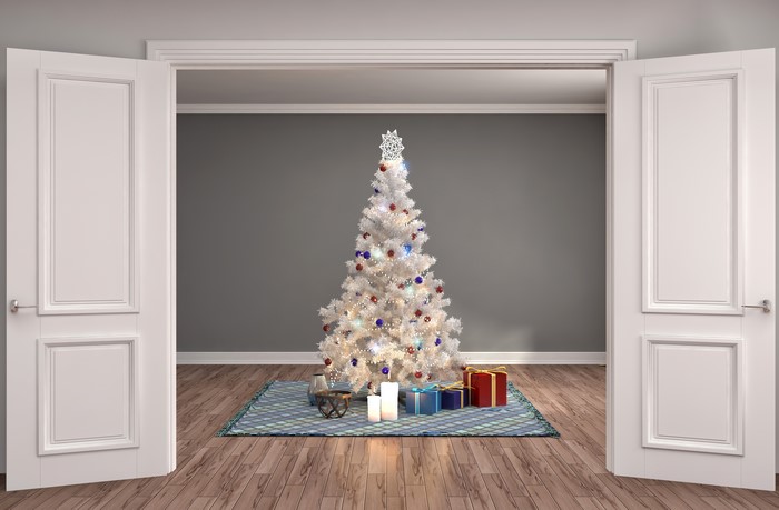 Christmas tree with gifts and candles in a room