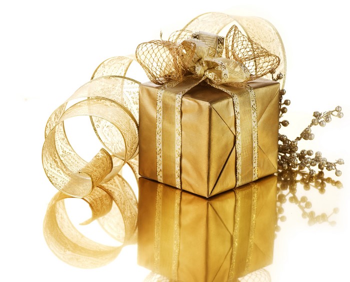 Gold gift box with ribbon and branches