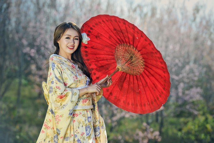 Smiling Woman in Floral Kimono with Red Umbrella