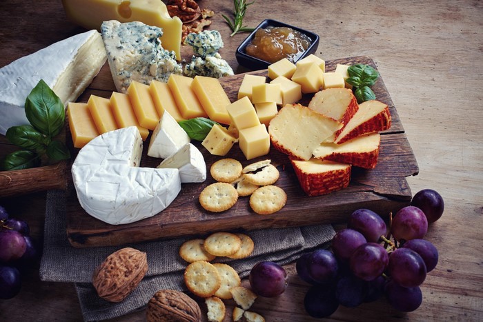Cheese, Grapes, Cookies, Nuts, and Cutting Board