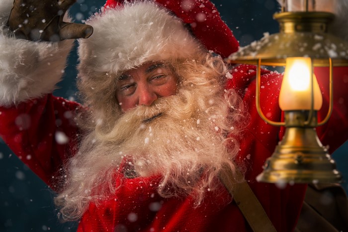 Santa Claus holding a lantern in the snow