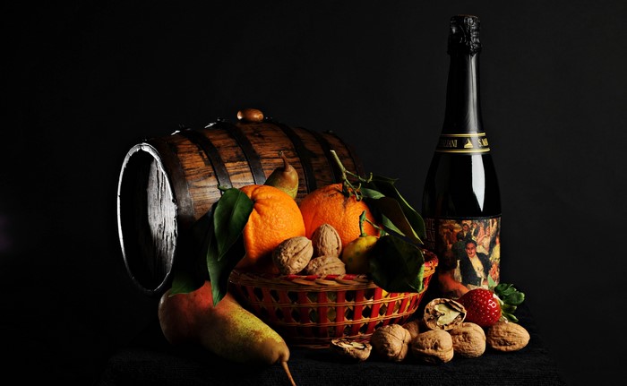 Still life with barrel, champagne, fruits, and nuts