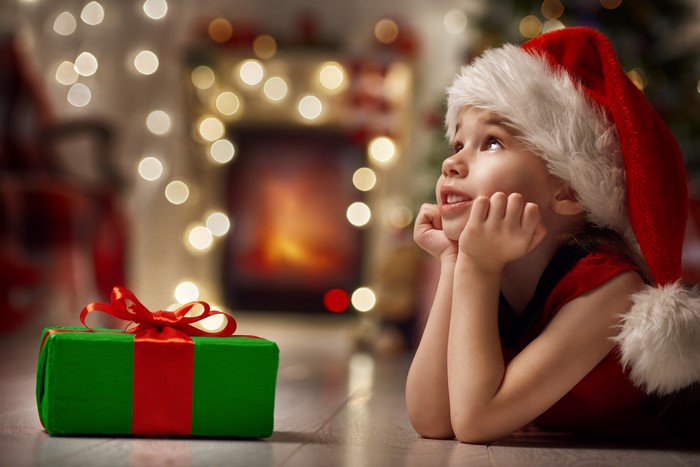 Girl in Santa hat with Christmas gift