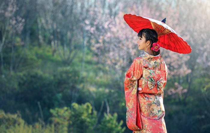 Woman in Kimono holding a red umbrella