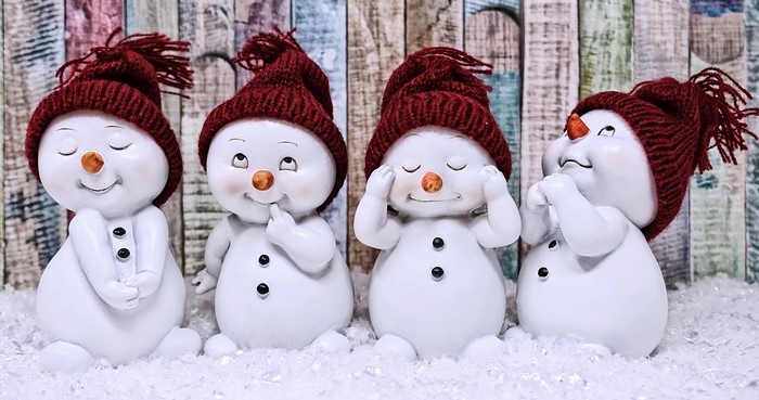 Four snowmen in winter hats