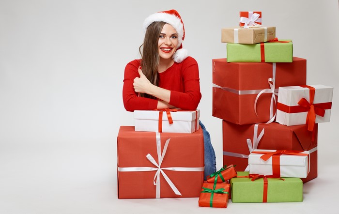 Woman in Santa hat with Christmas gifts