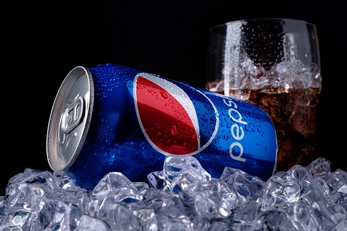 Pepsi can and glass with ice