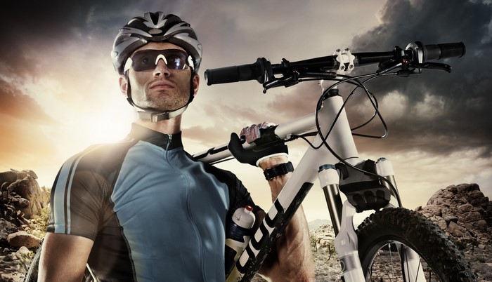 Man in cycling uniform with bicycle
