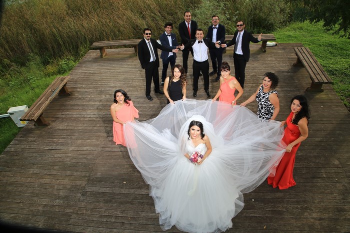 Wedding party with bride and groom on wooden deck