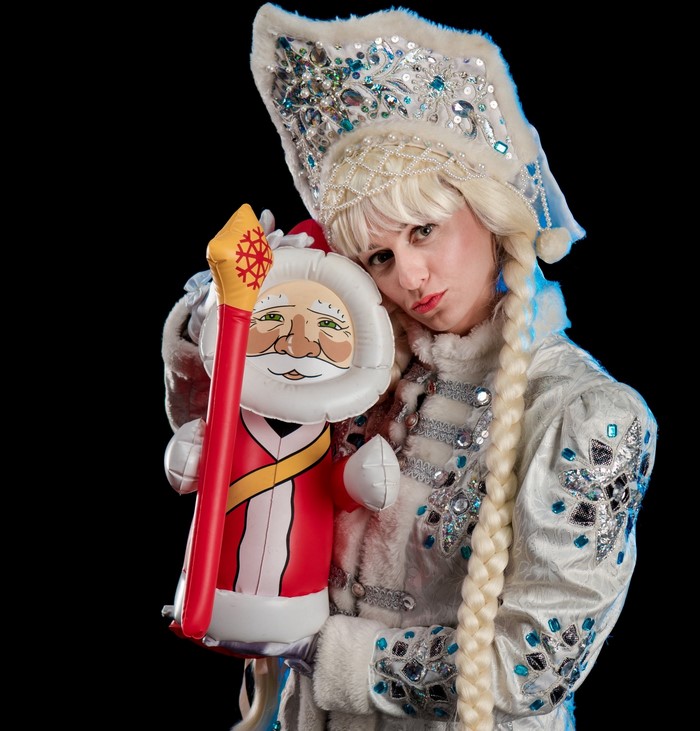 Snow Maiden holding an inflatable Santa Claus