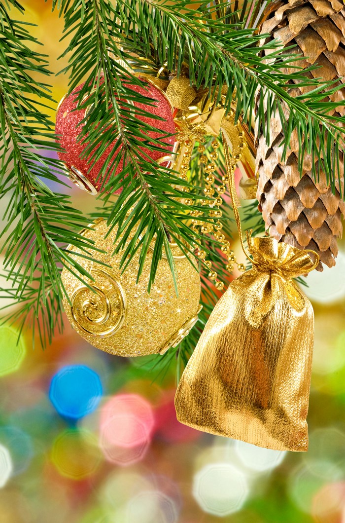 Christmas tree branches with ornaments and pine cone