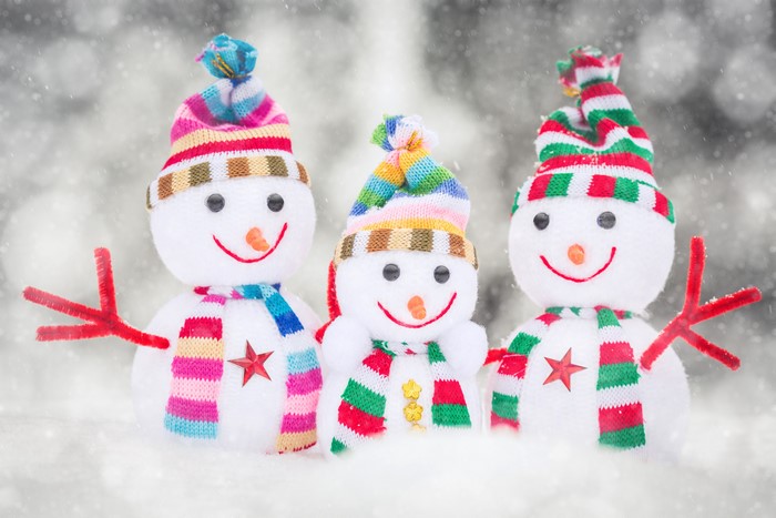Three snowmen with winter hats and scarves