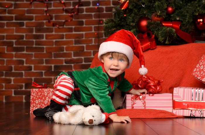 Boy in Elf Costume with Christmas Gifts