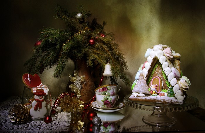 Christmas still life with gingerbread house and cookies