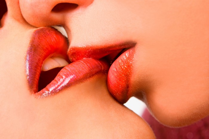 Two people kissing with red lips