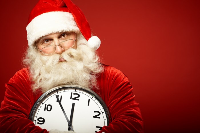 Santa Claus holding a clock