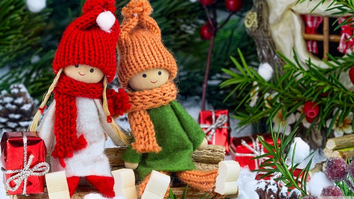 Two Christmas dolls with hats and scarves