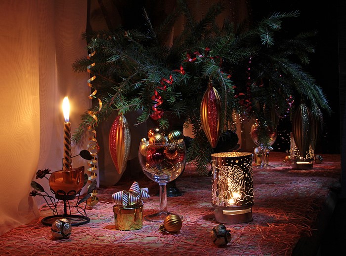 Christmas tree branches with ornaments and candles
