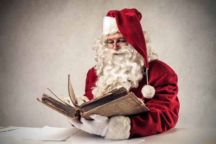 Santa Claus reading an old book