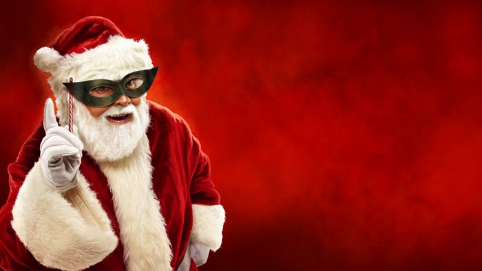 Santa Claus wearing a mask and holding a candy cane