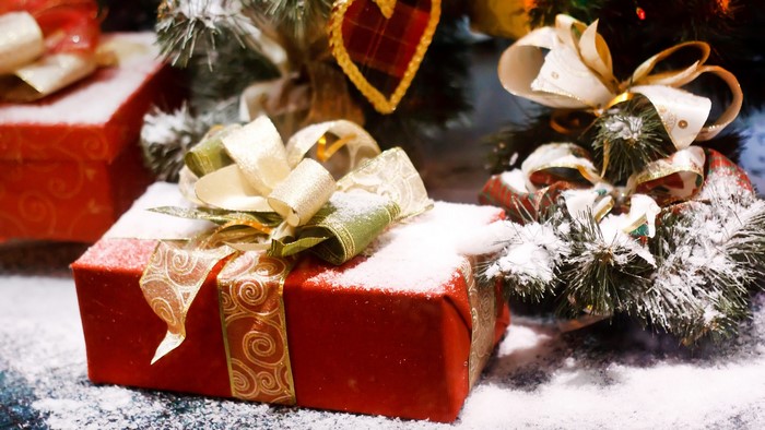 Christmas gifts under a tree with snow