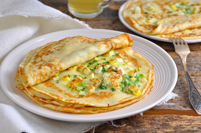 Pancakes with egg and chives on a plate