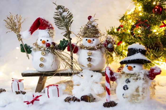Three snowmen with Christmas tree and gifts