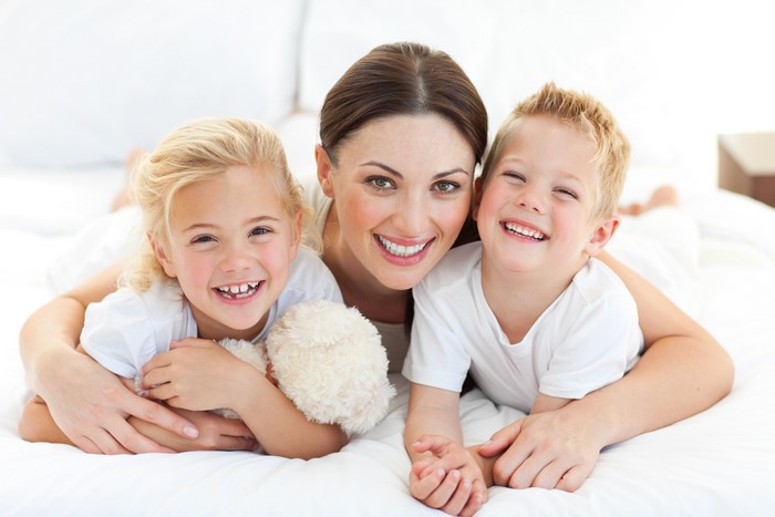 Mother hugging her son and daughter