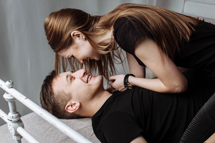 Couple laughing on a bed