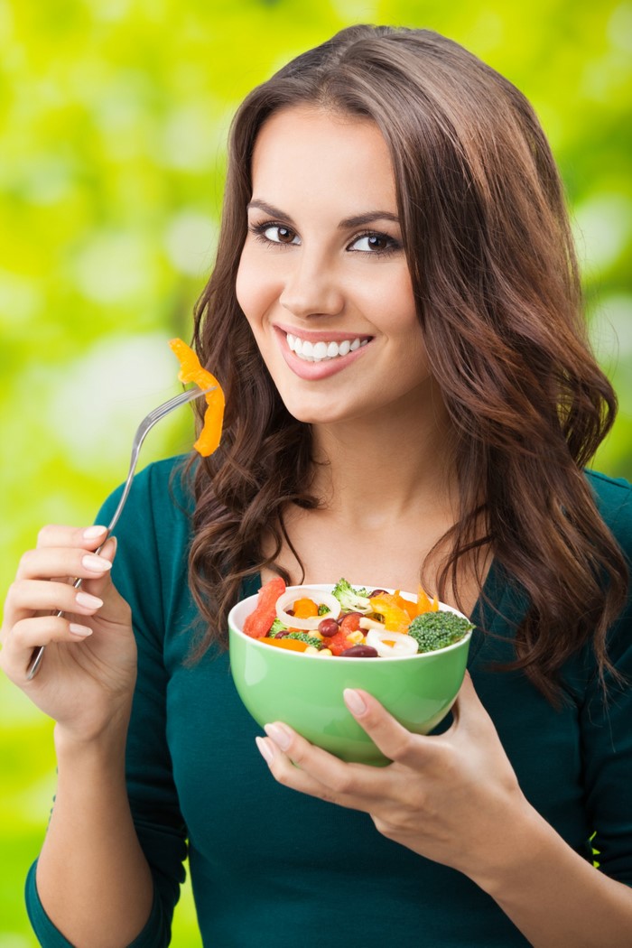 Woman eating salad with fork