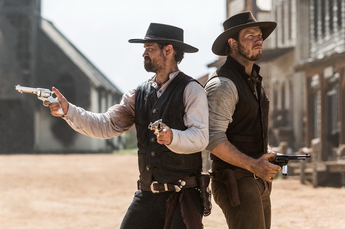 Two cowboys with revolvers in a Western town