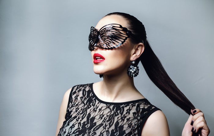 Woman with butterfly mask and lace dress
