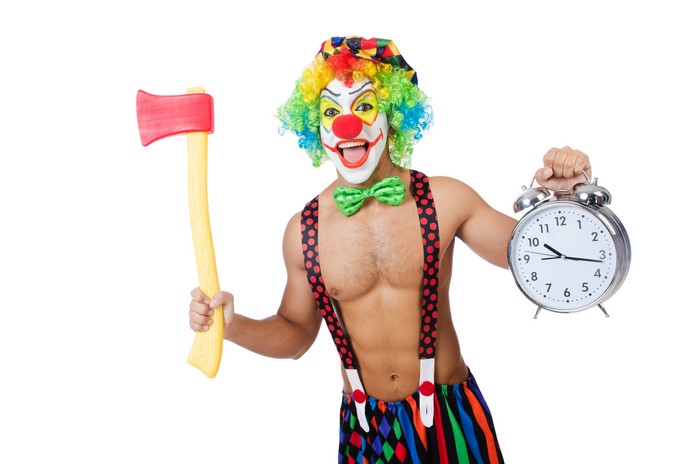 Clown with Axe and Alarm Clock on White Background