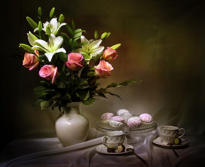 Still-life with roses, lilies, marshmallows, and tea cups