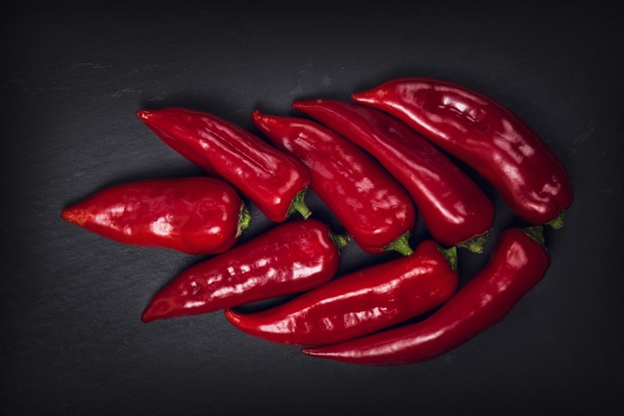 Red chili peppers on a dark surface