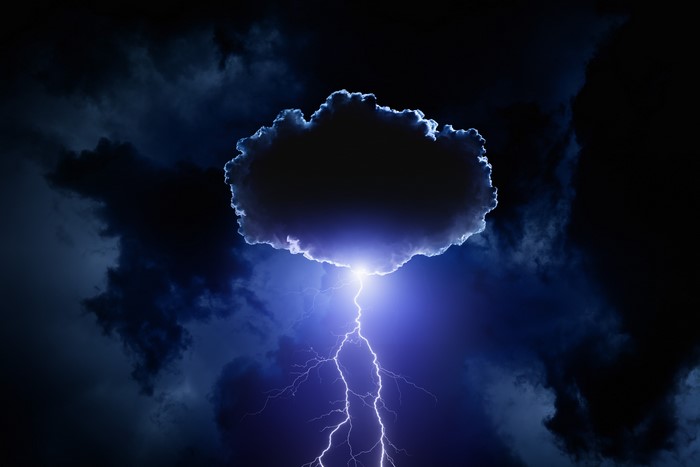 Lightning striking from a dark cloud in the night sky