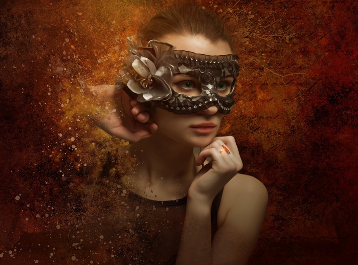 Woman wearing a decorative mask with a flower