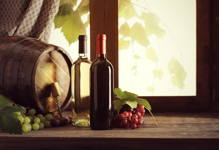 Wine barrel with bottles and grapes