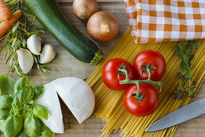 Ingredients for Pasta Dish: Tomatoes, Mozzarella, Zucchini, Garlic, Onions, Herbs, Spaghetti
