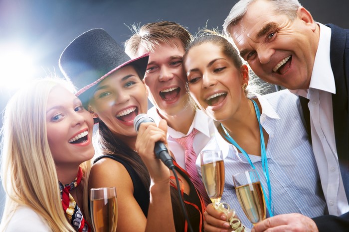 Group of people singing with champagne